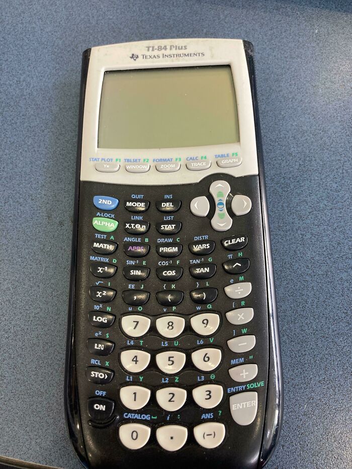 Old Texas Instruments calculator with c*****d screen and missing buttons showing damage from borrowing misuse