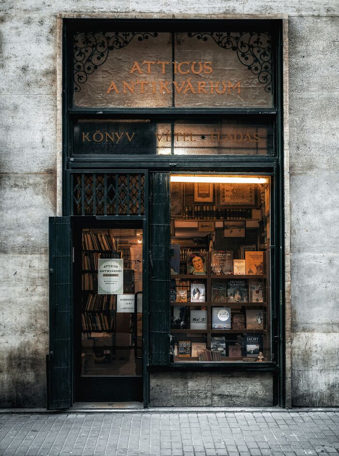 Exterior view of a stunning and impressive bookstore with vintage decor and books displayed in the window.
