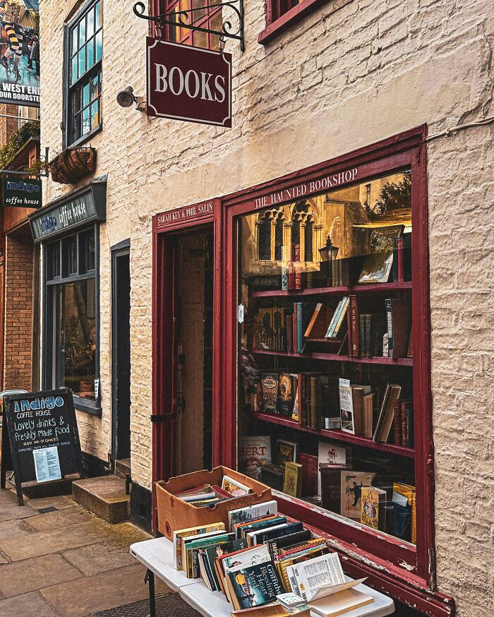 Charming bookstore exterior with books displayed outside on a table, showcasing one of the most stunning and impressive bookstores.