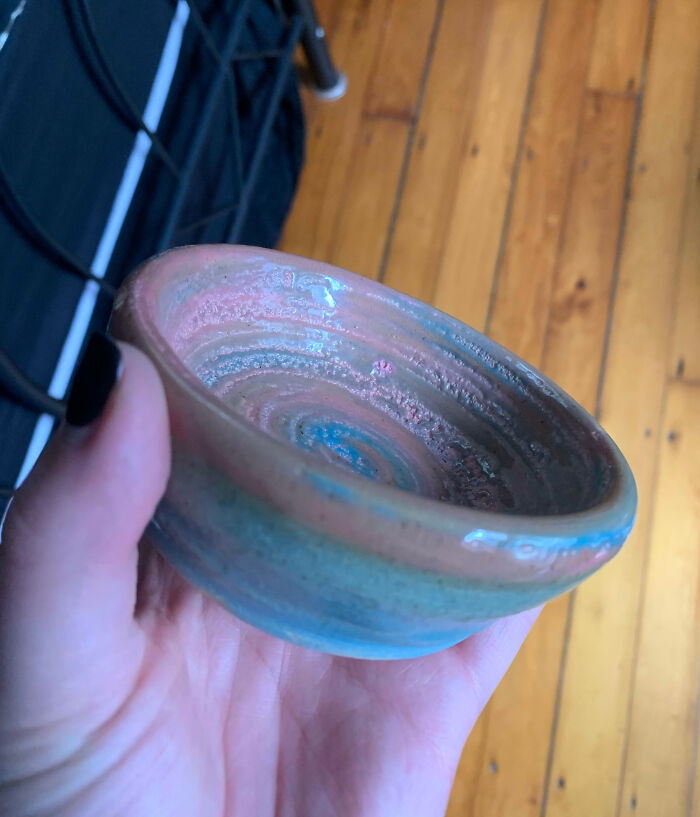 Handcrafted pottery bowl held by hand, showcasing art and creativity symbolizing teachers who love their students and profession.