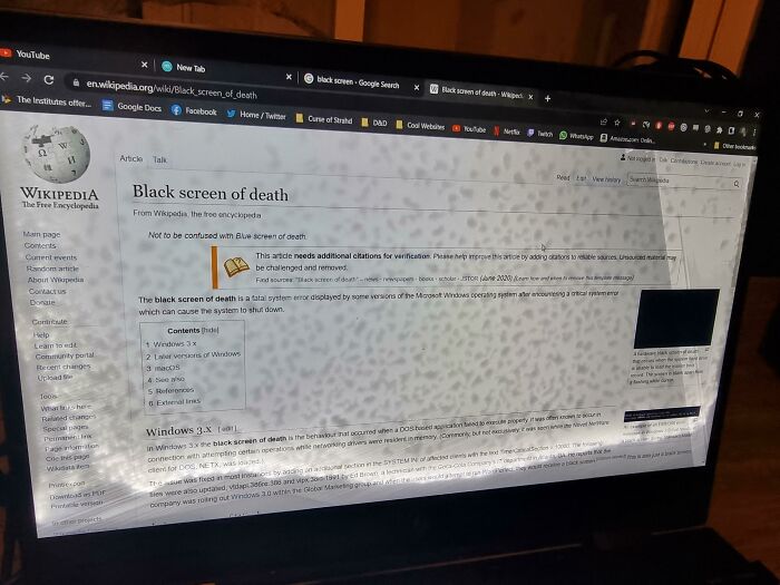 Laptop screen displaying a Wikipedia article with visible water damage, illustrating borrowing damage concepts.