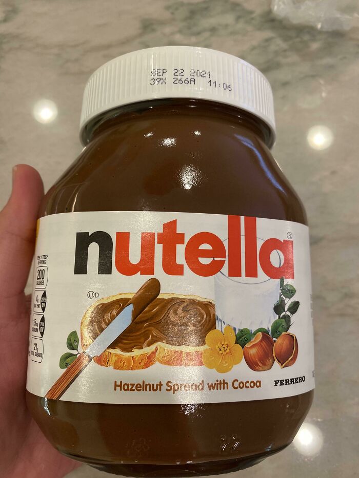 Hand holding a jar of Nutella hazelnut spread, an unexpected item flagged by airport security.