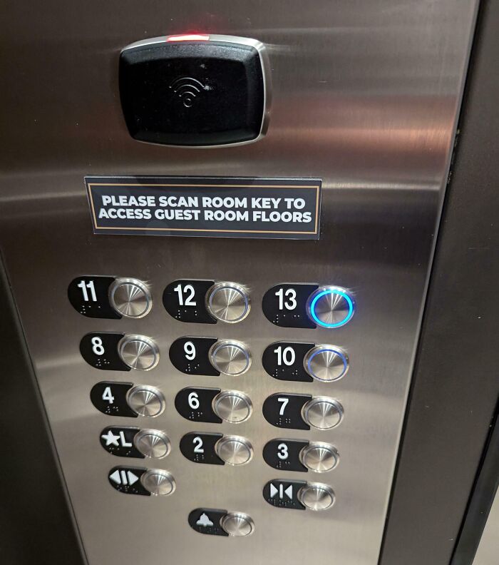 Elevator panel in hotel requiring room key scan for guest room floor access showing floor buttons and security feature.