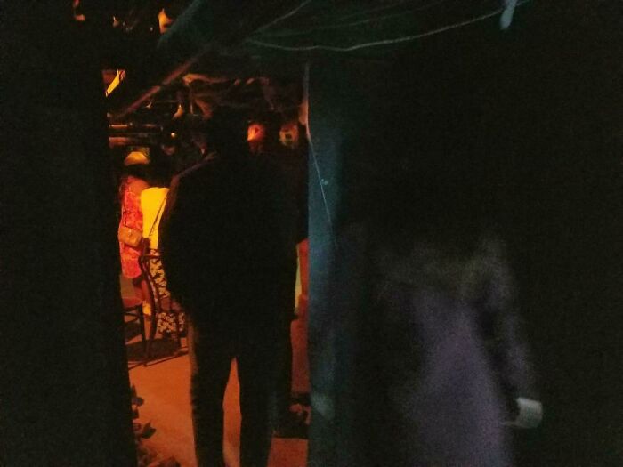 Dimly lit basement showing shadowy figures and a ghostly apparition, evoking chilling ghost encounters.