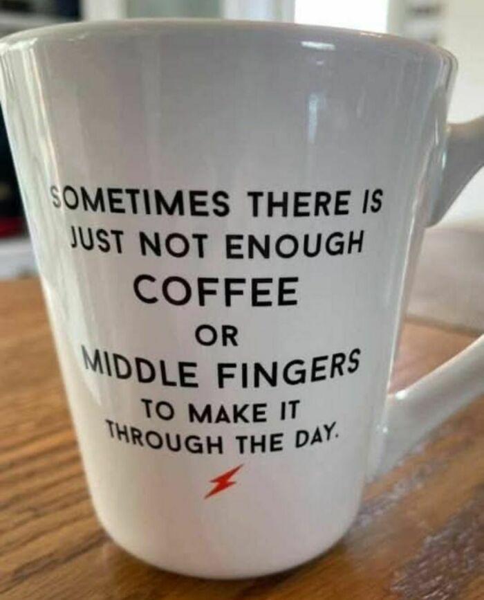 White coffee mug with a humorous meme about coffee and middle fingers to get through the day, highlighting powerful memes.