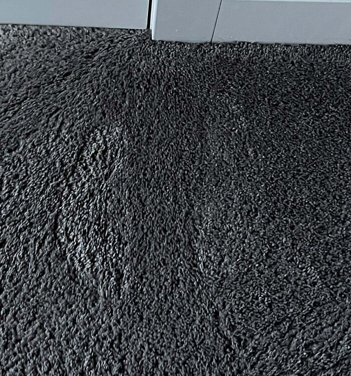 Shadowy ghostly footprints appear on dark carpet near door, evoking chilling ghost encounters atmosphere.