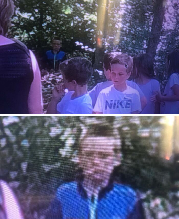 Faint ghostly figure in blue appears among children in a forest, a chilling ghost encounter captured on camera.