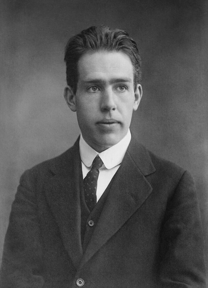 Black and white portrait of a handsome historical figure in a suit and tie, showcasing famous names from history.