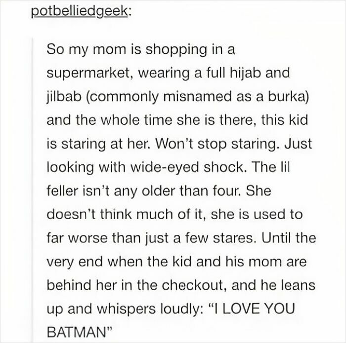 Child staring wide-eyed at woman in hijab, then whispers love for Batman, a feel-good post restoring faith in humanity.