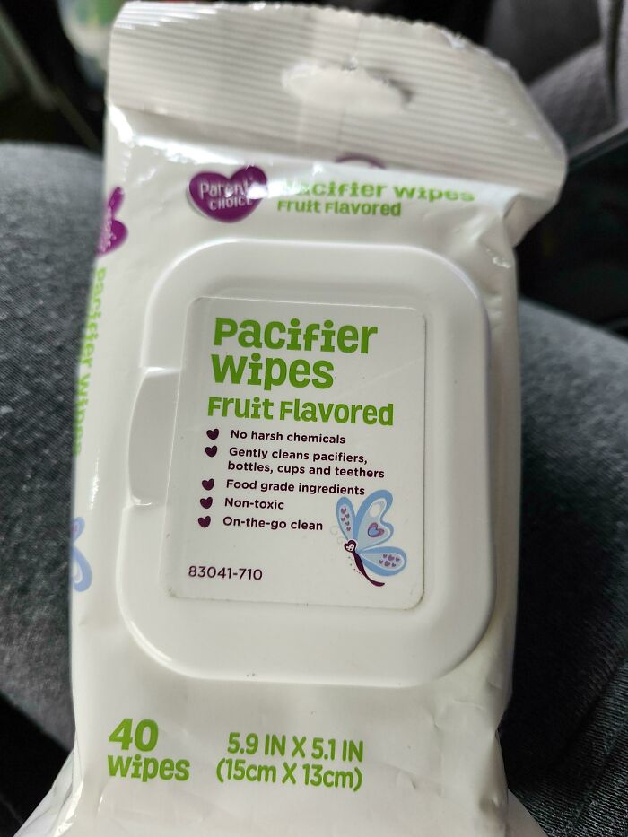 Pacifier wipes package labeled fruit flavored with cleaning benefits, shown in a funny pic capturing utter confusion.