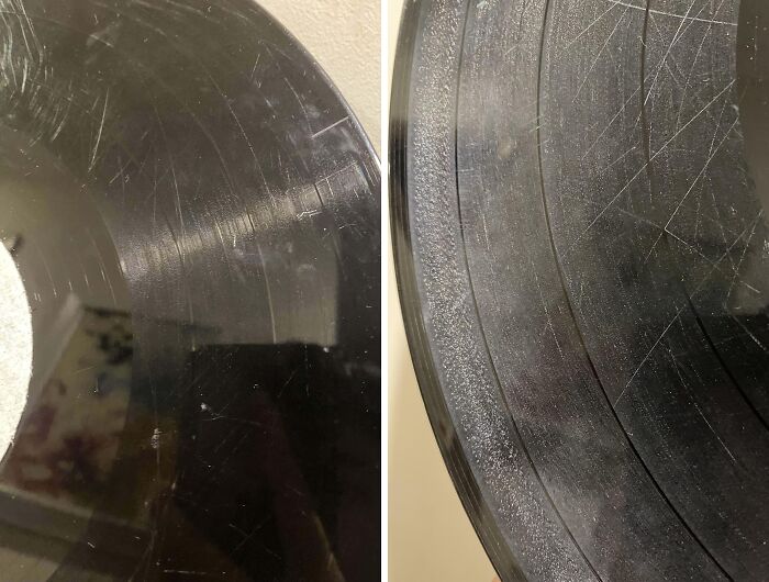 Scratched and damaged borrowed vinyl record showing clear wear and tear from misuse by others.