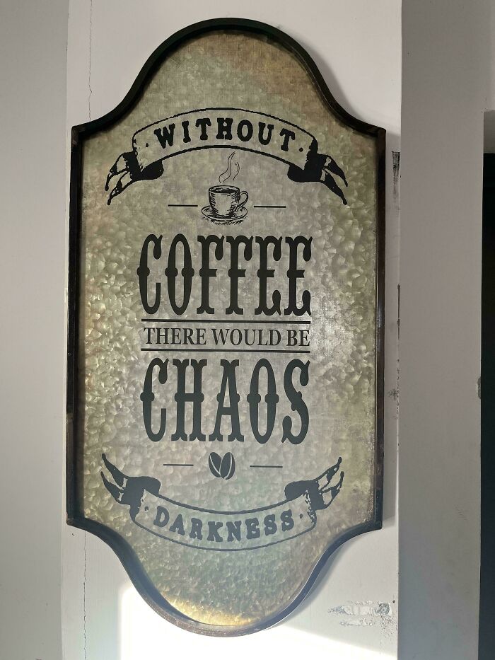 Vintage metal sign about coffee humor with text highlighting chaos and darkness in a rustic setting, funny pics theme.