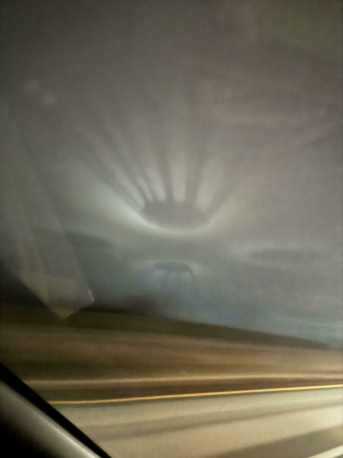 Shadow of an object creating a strange circular pattern on a foggy car window in a funny pic that shows confusion.