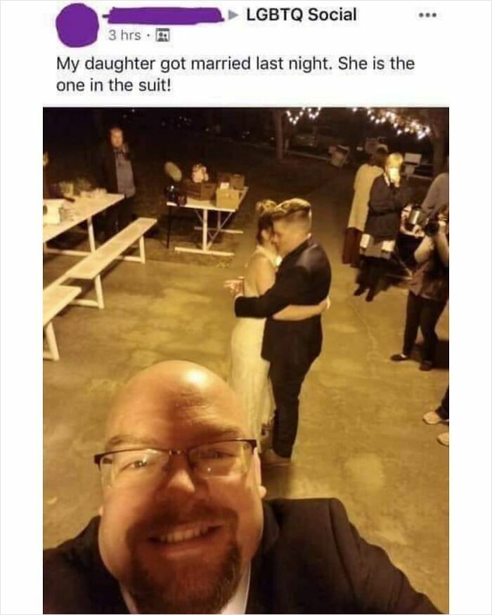 Man smiling in a selfie while a couple embraces in the background at a feel-good wedding celebration restoring faith in humanity.