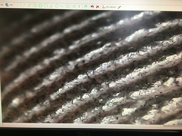 Close-up microscopic image showing detailed texture and patterns of an ordinary object with a unique perspective.