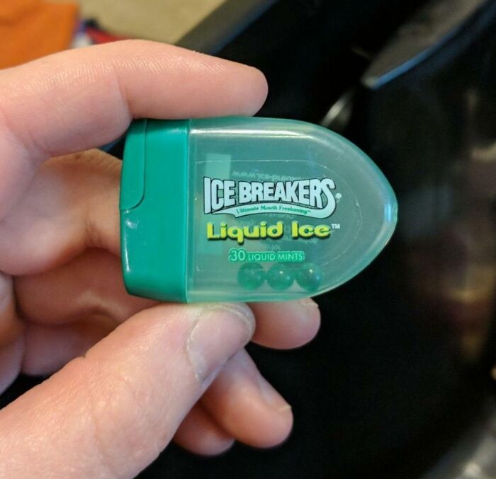 Hand holding Ice Breakers Liquid Ice mint container, one of the beloved foods and drinks that disappeared.
