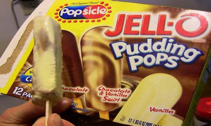 Jell-O Pudding Pops box and partially eaten popsicle representing beloved foods that disappeared from the market.