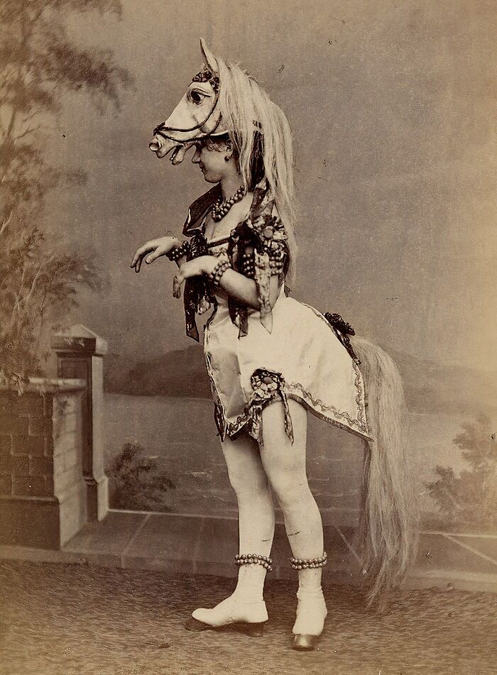 Victorian times strange moment featuring a person dressed in a detailed horse costume with accessories and tail.