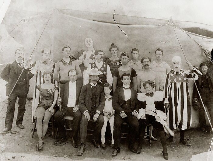 Group portrait of Victorian circus performers in costume, showcasing strange moments from Victorian times still fascinating today