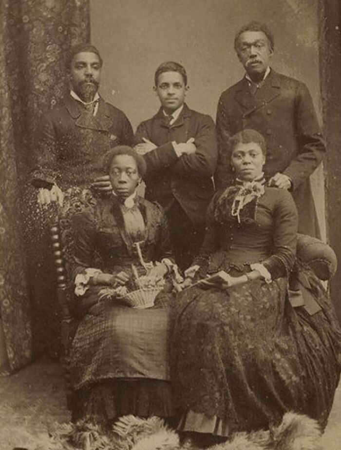 Victorian times group portrait of five people in period clothing showcasing fashion from unusual Victorian moments.