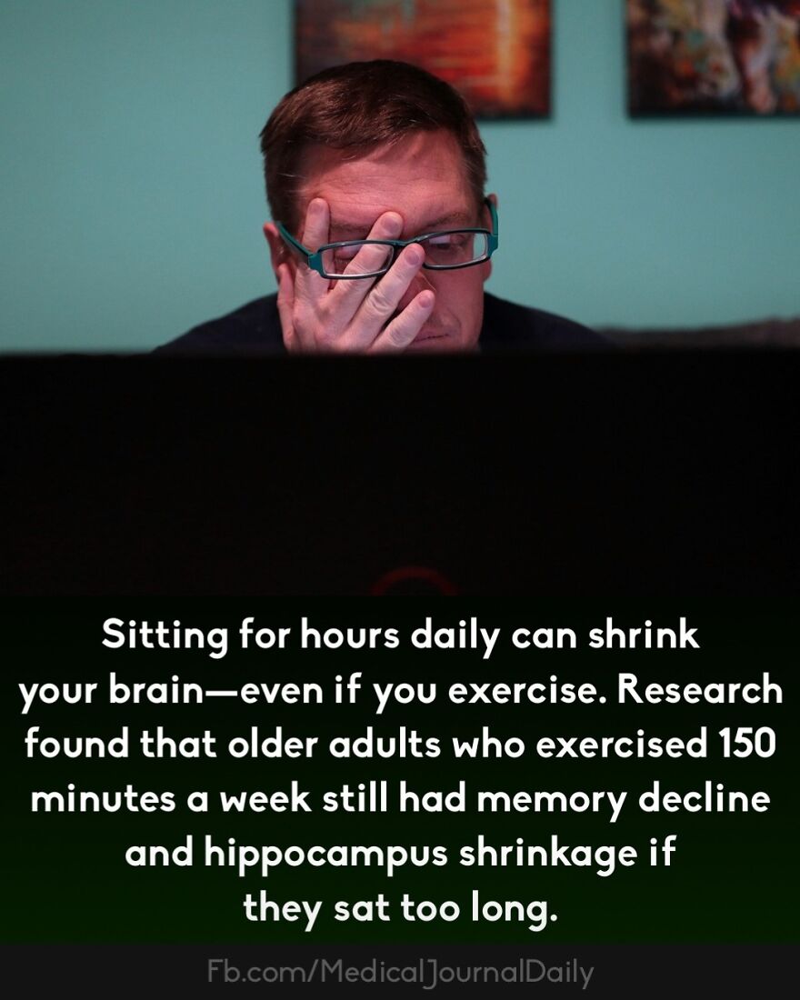 Man wearing glasses resting his face on hand while looking at a screen, highlighting fingers contain no muscles fact.