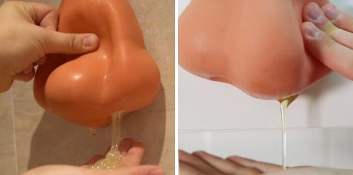 Hand squeezing a novelty nose-shaped kitchen gadget dispensing liquid soap over a sink and onto a hand.