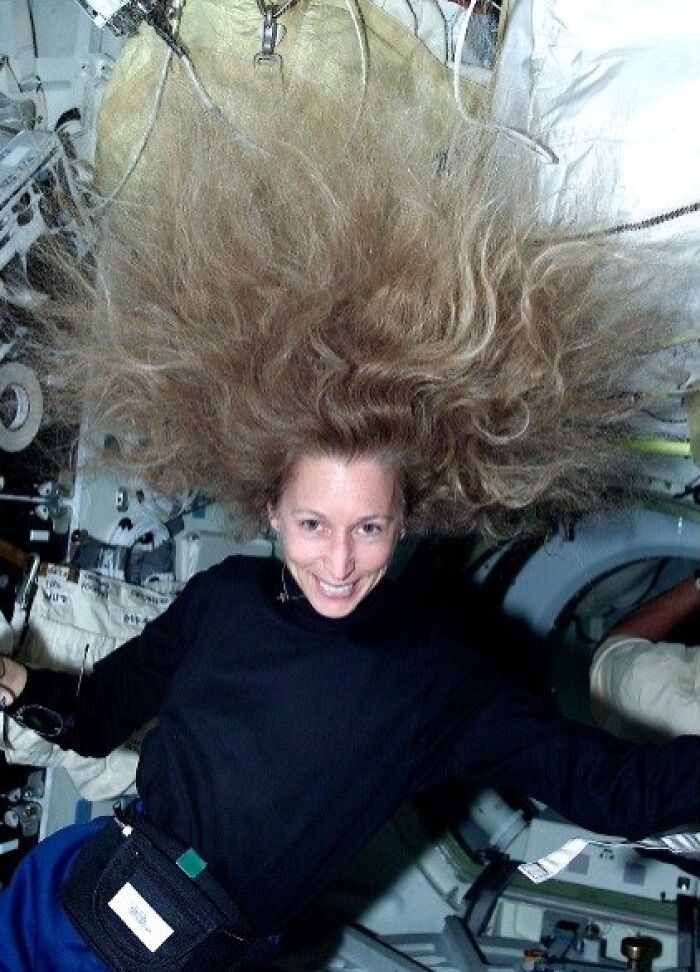 Woman floating with hair spread in zero gravity inside a spacecraft, related to scary and unsettling Wikipedia articles.