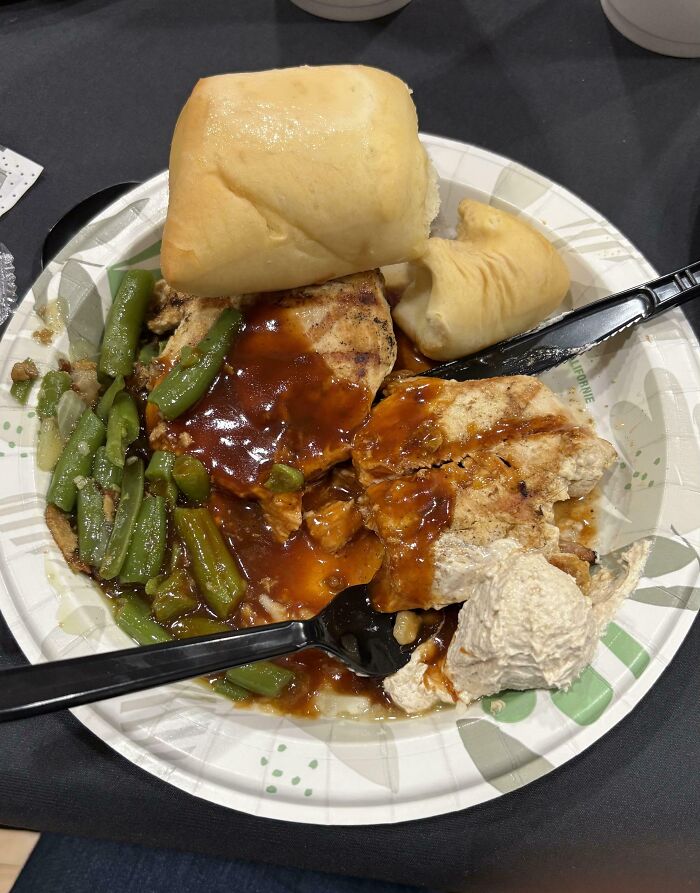 Plate of mashed potatoes with gravy, green beans, grilled chicken, and rolls, illustrating hilariously unlucky parents' mealtime mishaps.