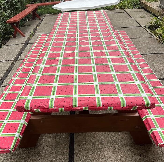 Picnic table covered with a watermelon-patterned cloth, ideal for an international picnic day al fresco feast.