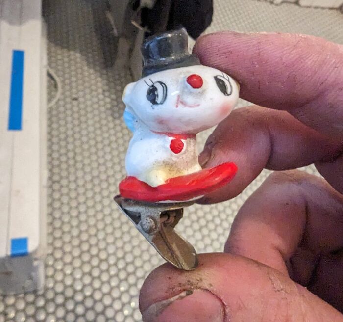 Small vintage toy figurine found among unexpected things hidden in walls and other hidden places in homes