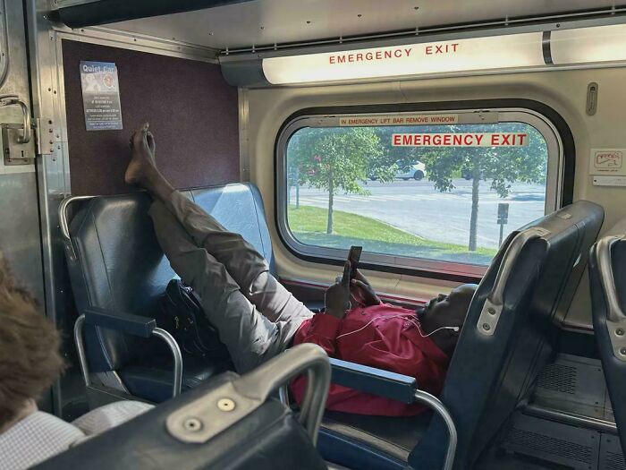 Passenger lying across seats with feet up on public transport, disregarding etiquette and disturbing fellow commuters.