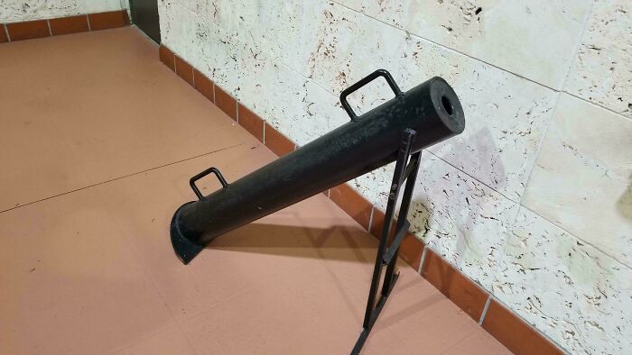 Black metal mystery object with handles and stand, featured in an online group helping identify unusual items.