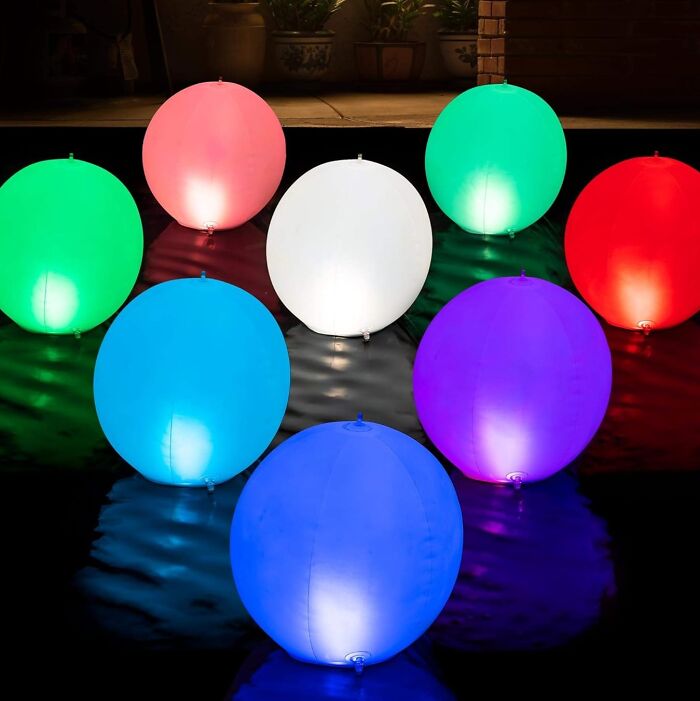 Colorful illuminated outdoor spheres glowing on a patio, demonstrating creative ways to light up your outdoor space at night.