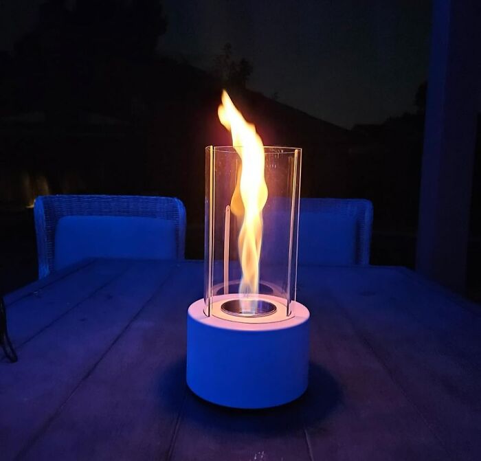 Modern outdoor flame lantern on a patio table providing stylish lighting for usable outdoor space after dark