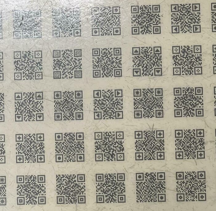 A sheet covered with multiple small QR codes closely arranged, an interesting pattern requiring a double take.