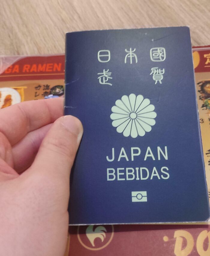 A person holding a booklet with Japanese characters and the words Japan bebidas, an interesting item requiring a double take.