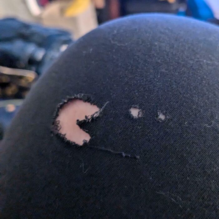 Close-up of a torn black fabric that looks like a Pac-Man shape, one of the interesting things that required a double take.