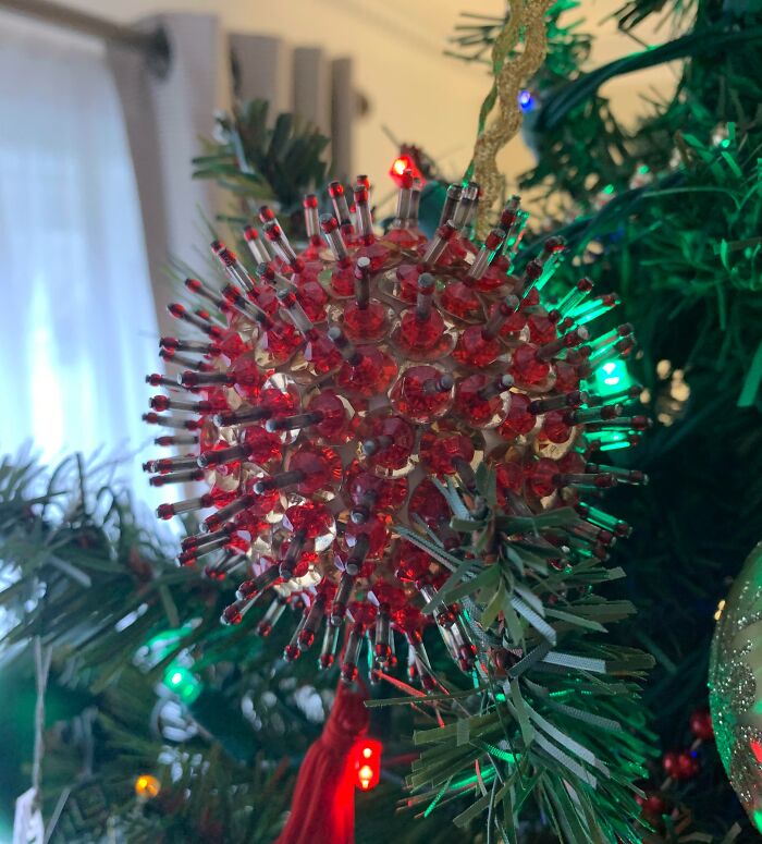 Close-up of a decorative ornament on a Christmas tree that looks like a virus in interesting things double take.