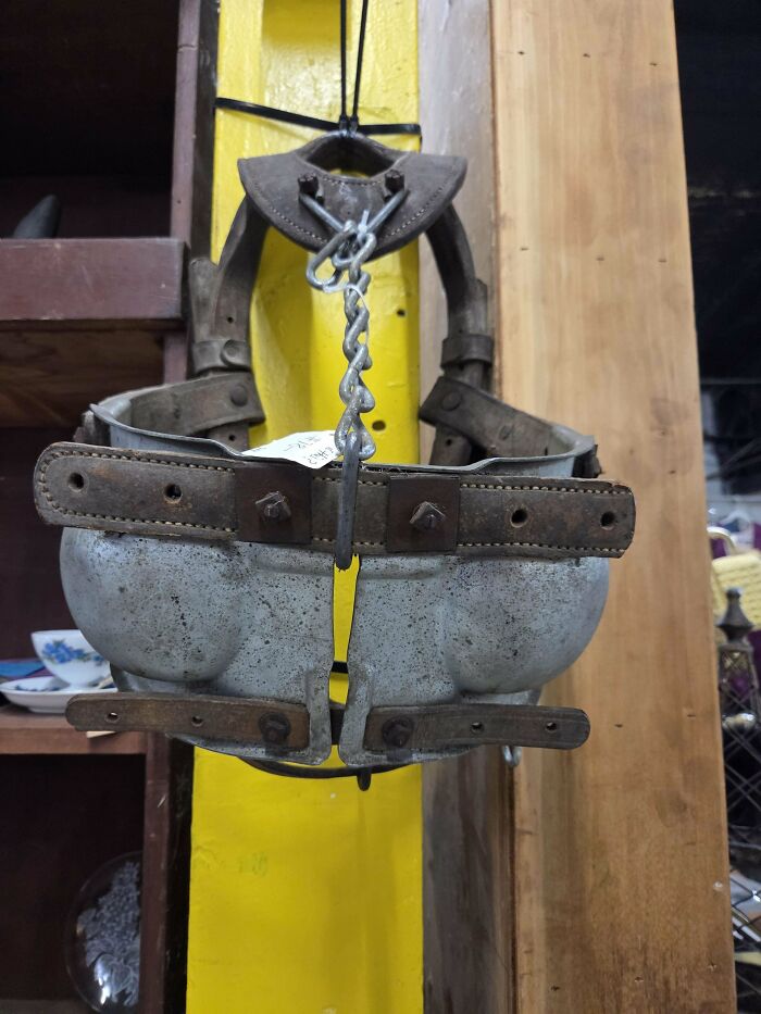 Vintage mystery object with leather straps and metal cups, featured in an online group recognizing unusual items.