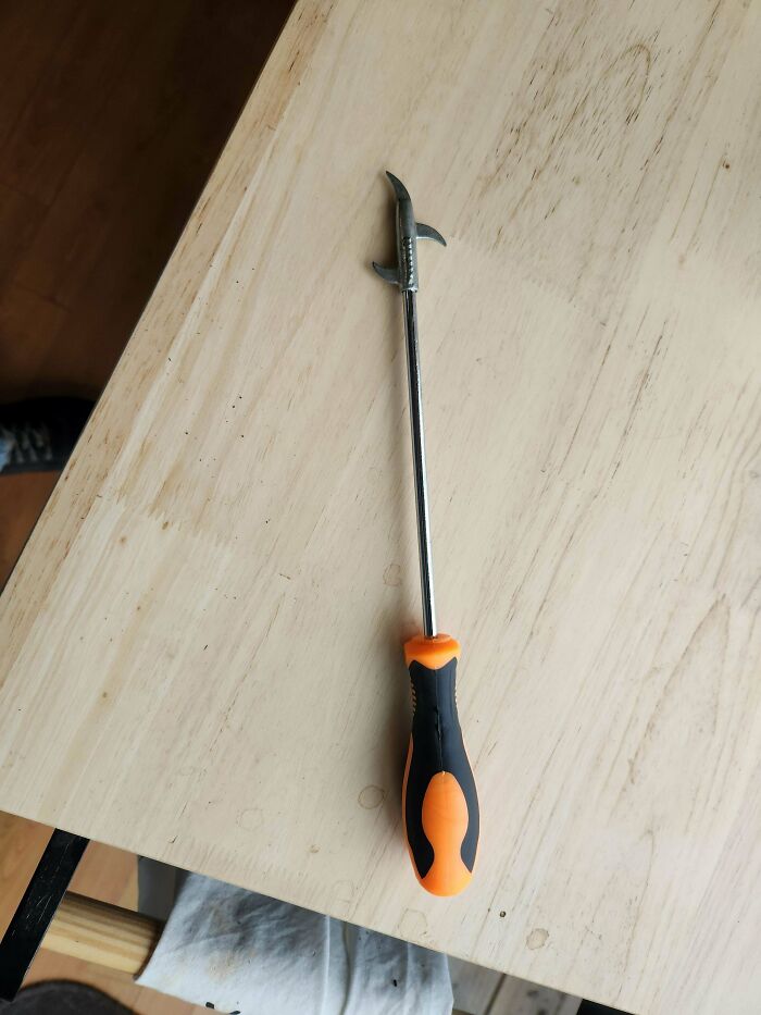 Tool with orange and black handle and hooked metal end, one of the mystery objects recognized by an online group.