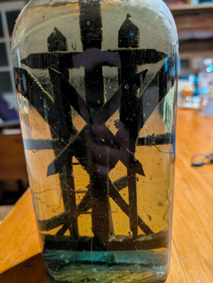 Close-up of a mystery object submerged in liquid inside a glass container, featured in an online group helping recognize objects.