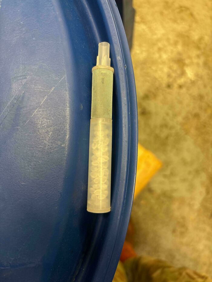 Mystery object with a mesh grip and white pellets inside, part of a collection of recognized mystery objects online.