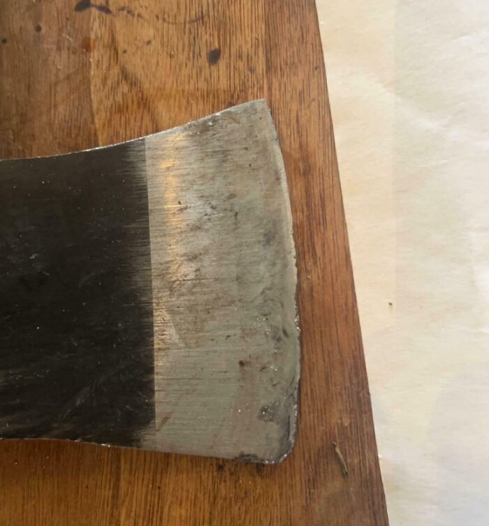 Worn and damaged axe blade showing the effects of people damaging things they borrowed in everyday use.