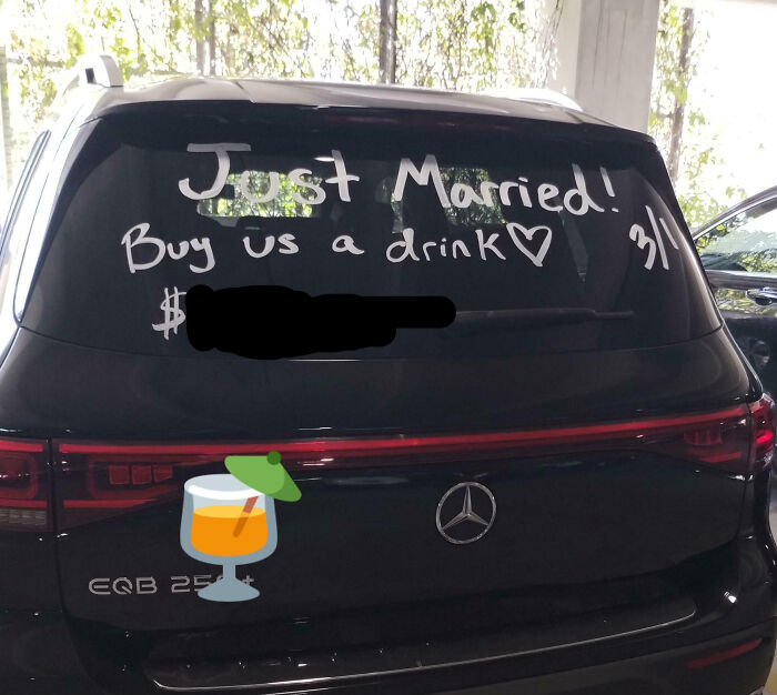 Black Mercedes SUV with "Just Married! Buy us a drink" written on the rear window, showcasing entitlement moments.