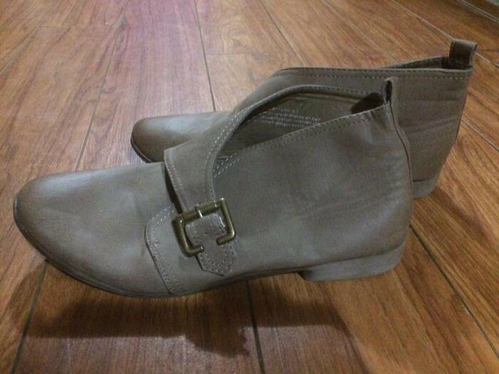 Pair of gray shoes on a wooden floor casting cool and interesting shadows that make people look twice.