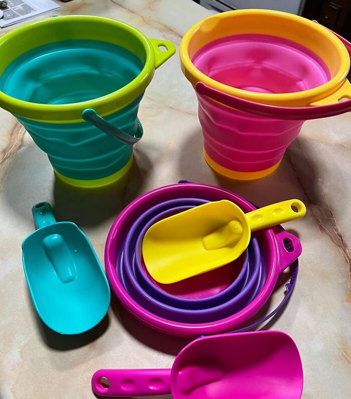 Colorful collapsible beach buckets and scoops arranged on a table, perfect finds to conquer sun, sand, and snack attacks.
