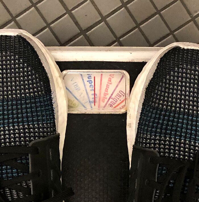 Close-up of feet on an old gym scale showing weight, illustrating annoying gym moments and workout frustrations.