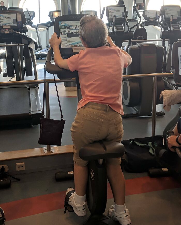 Older woman using gym equipment awkwardly, highlighting annoying gym moments that make running in the rain seem better.