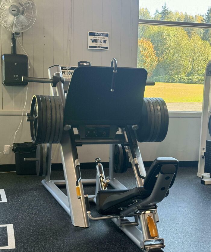 Leg press machine loaded with multiple weight plates in a gym, illustrating annoying gym moments and workout challenges.