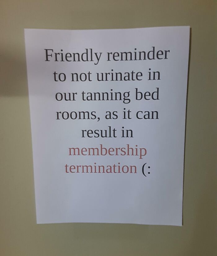 Sign warning gym members not to urinate in tanning bed rooms to avoid membership termination as annoying gym moments.